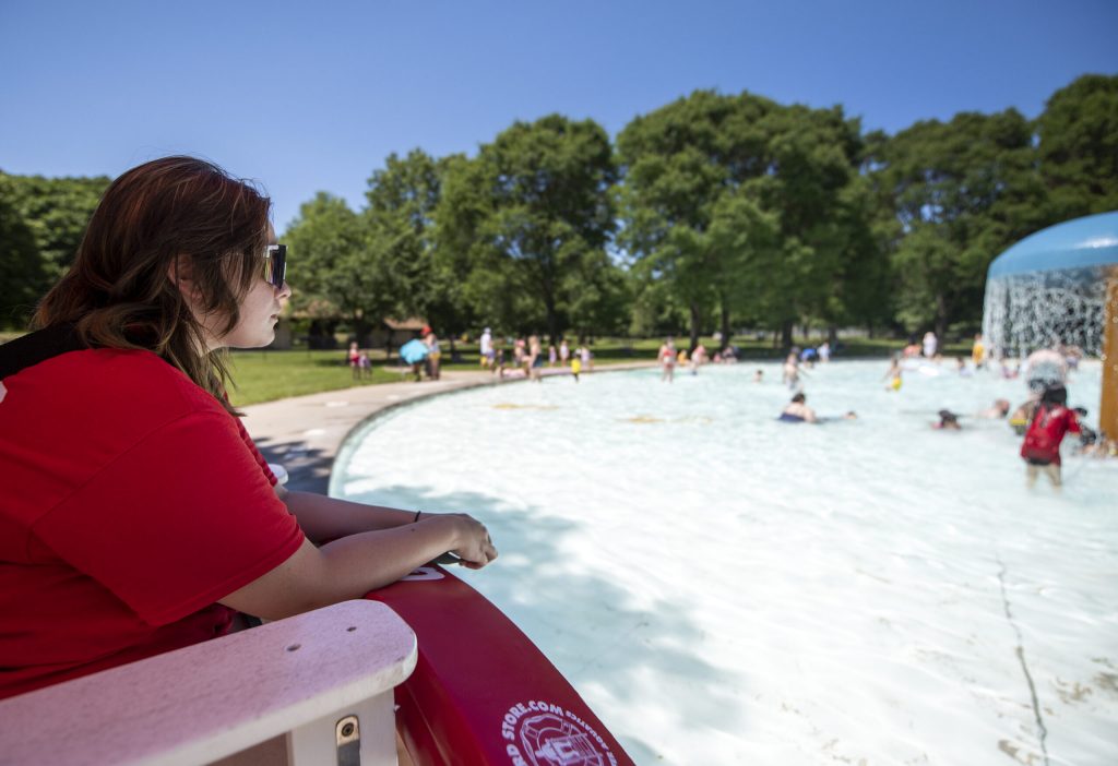 A lifeguard watches over a splash pool Monday, June 20, 2022, at Palmer Park in Janesville, Wis. Angela Major/WPR