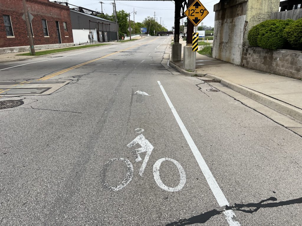 Vehicles have worn away paint on a S. Kinnickinnic Avenue bike lane that is to receive concrete protected lanes. Photo by Jeramey Jannene.