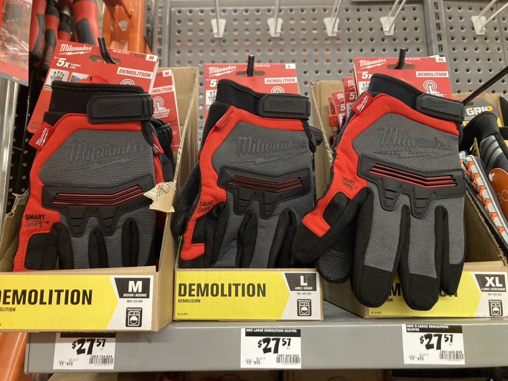 Milwaukee Tool “Demolition” gloves are seen at a Home Depot in Madison, Wis., on Feb. 5, 2023. Two men in 2023 told Wisconsin Watch they were forced to make Milwaukee Tool glove models under grueling conditions while incarcerated at Chishan Prison in China’s central Hunan Province. Milwaukee Tool has repeatedly said it has found no evidence of forced labor within its supply chain. (Zhen Wang / Wisconsin Watch)