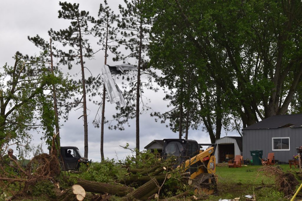 Debris is seen in a tree as workers clean up tornado damage in Unity, Wis., May 22, 2024. Rob Mentzer/WPR