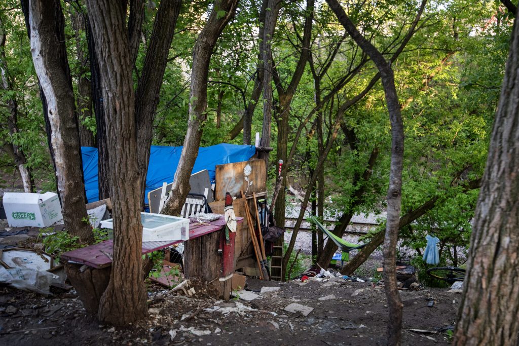Items are set up in an outdoor encampment near one of the stops made by the Street Angels bus Thursday, May 9, 2024, in Milwaukee, Wis. Angela Major/WPR