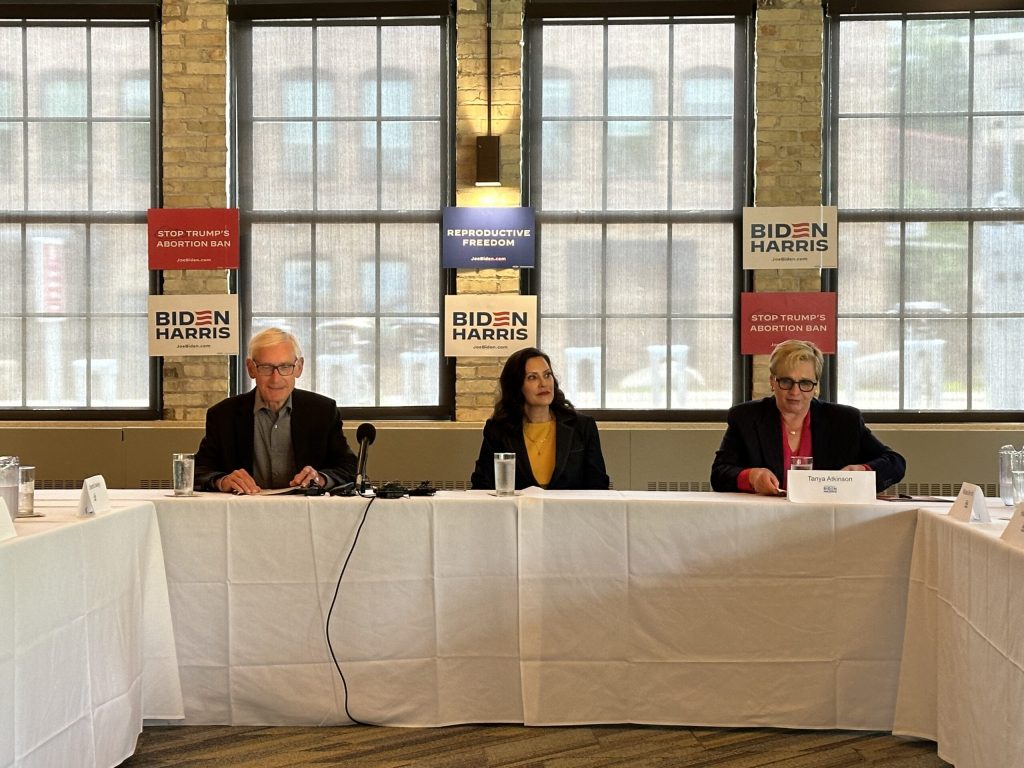 Michigan Gov. Gretchen Whitmer, center, joins Gov. Tony Evers, left, and Tanya Atkinson, president of Planned Parenthood Wisconsin, right, at a panel focused on abortion access in Madison, Wis., on June 17, 2024. Anya van Wagtendonk/WPR