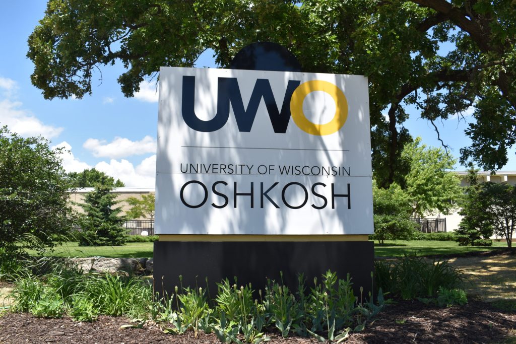 A University of Wisconsin-Oshkosh sign is seen from Wisconsin Street in Oshkosh on Friday, June 14, 2024. (Joe Schulz/WPR)