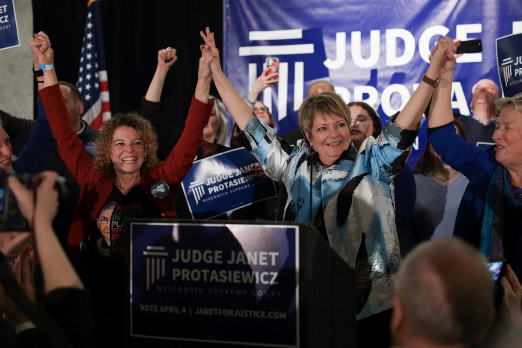 Justice Janet Protasiewicz, center, celebrates her victory on election night on April 4, 2023, with Justices Rebecca Dallet, left, Jill Karofsky, far left, and Ann Walsh Bradley, far right. The liberal majority has moved quickly to assert its control over the court. Drake White-Bergey/Wisconsin Watch