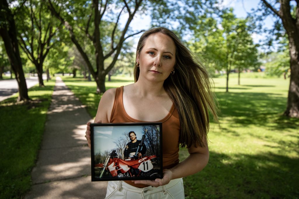 Megan Hoffmann Kolb, daughter of Dean Hoffmann, who was found dead by suicide a year ago, holds a photograph of her father Wednesday, July 3, 2024, in Cedarburg, Wis. (Angela Major/WPR)