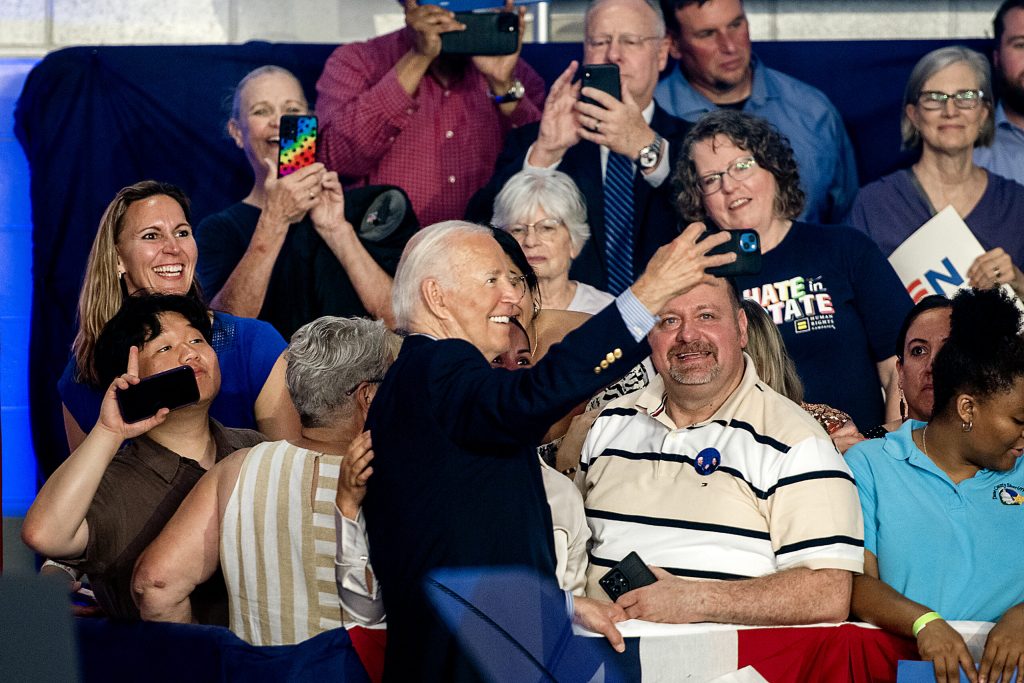 President Joe Biden takes a selfie with supporters Friday, July 5, 2024, at Sherman Middle School in Madison, Wis. Angela Major/WPR