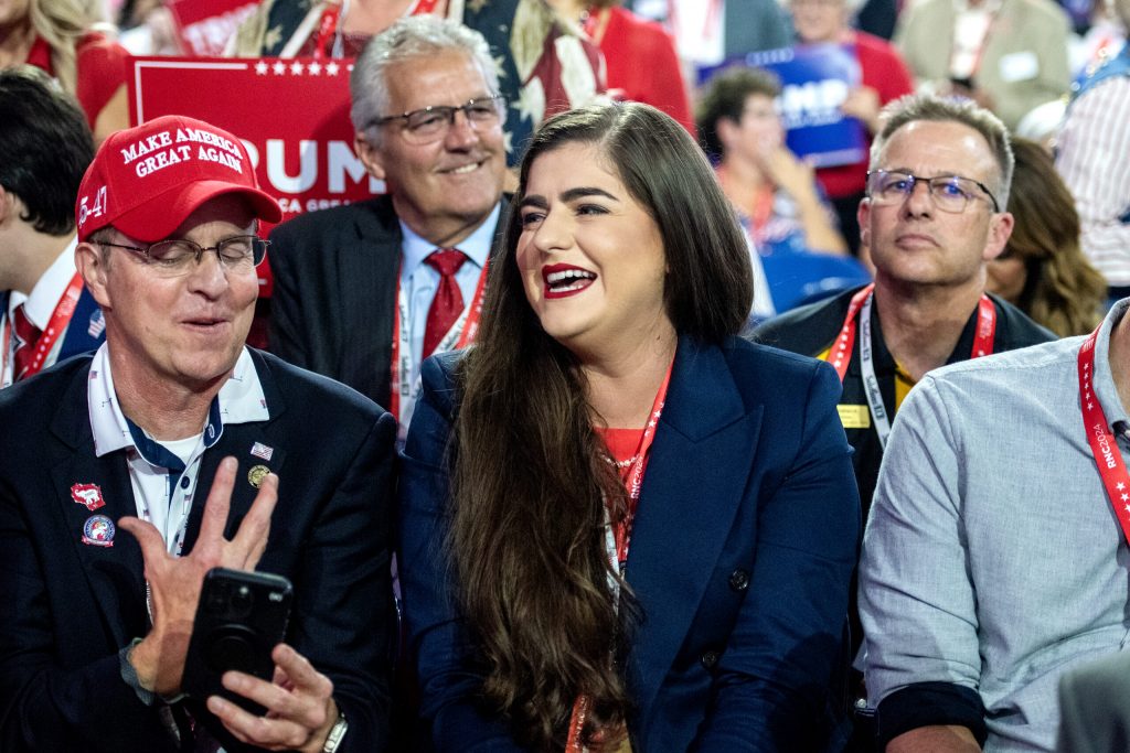 Andreina Patilliet, chairwoman of the Republican Party of Rock County, center, smiles during the second day of the RNC on Tuesday, July 16, 2024, at the Fiserv Forum in Milwaukee, Wis. Angela Major/WPR