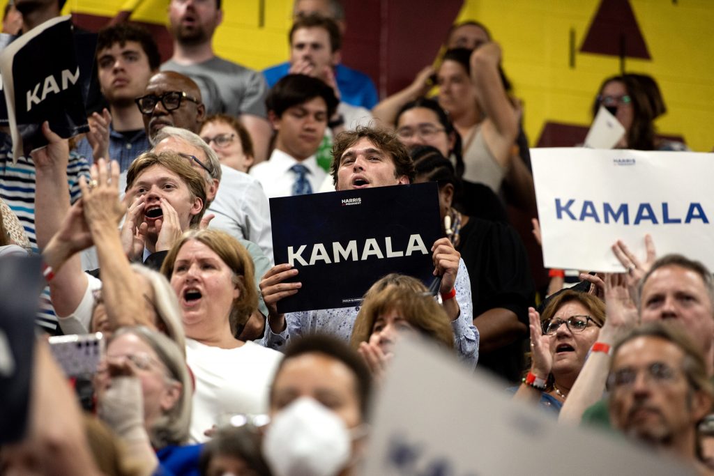 Supporters hold signs and cheer as Vice President Kamala Harris speaks Tuesday, July 23, 2024, at West Allis Central High School in West Allis, Wis. Angela Major/WPR