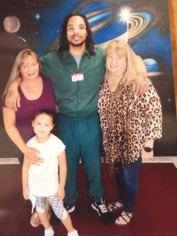 Tresa Hewlett, left, stands next to her son Damien Hewlett, center, about two years ago. This photo is the most recent time Tresa Hewlett has seen her son in person while he is incarcerated at Waupun Correctional Institution. Also in the photo are Damien Hewlett’s grandmother, Jill, and his niece. Photo courtesy of Tresa Hewlett
