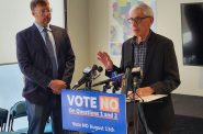 Gov. Tony Evers speaks at a press conference Monday  with Democratic Party of Wisconsin Chair Ben Wikler, left, opposing two referendum questions on the Aug. 13 primary ballot for an amendment to the Wisconsin Constitution that would end the governor’s authority to allocate federal funds. (Wisconsin Examiner photo)