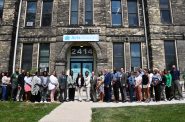 Mayor Cavalier Johnson, Congresswoman Gwen Moore and Acting HUD Secretary Adrianne Todman pose with members of ACTS Housing, HUD employees. Photo by Jeramey Jannene.