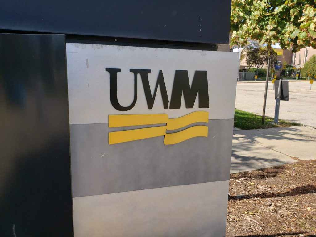 A University of Wisconsin-Milwaukee logo on a campus sign. (Wisconsin Examiner photo)