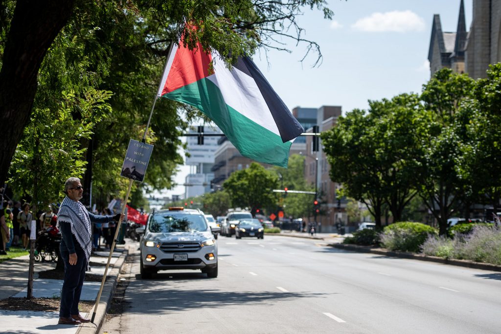 A protester holds a Palestinian flag near Union Park in response to the Democratic National Convention on Monday, Aug. 19, 2024, in Chicago, Ill. Angela Major/WPR