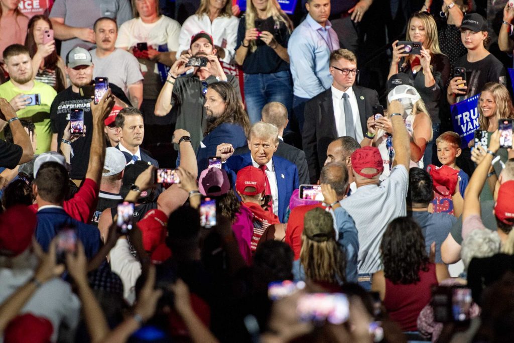 Former President Donald Trump walks through a crowd of supporters as he enters a rally on Aug. 29, 2024 in La Crosse, Wis. Angela Major/WPR