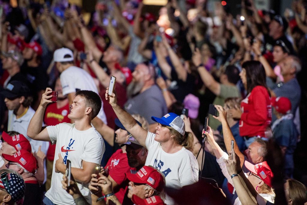 Attendees of a rally for former President Donald Trump take photos and videos with their cell phones on Aug. 29, 2024 at the La Crosse Center in La Crosse, Wis. Angela Major/WPR