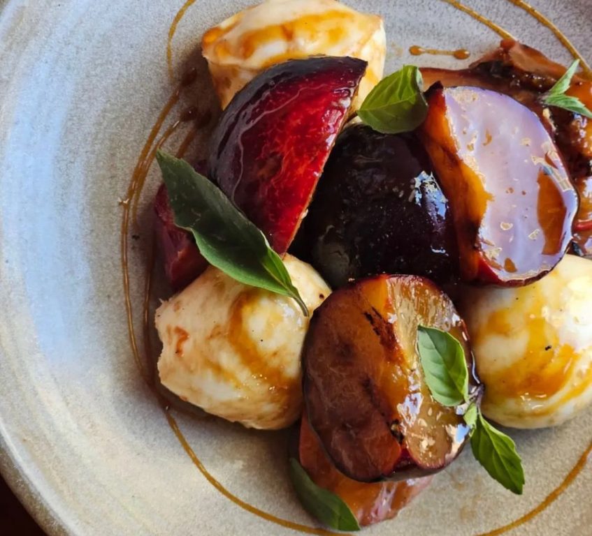 Grilled peaches and plums with bocconcini, Thai basil and ponzu reduction from Mother's. Photo courtesy of Vanessa Rose.