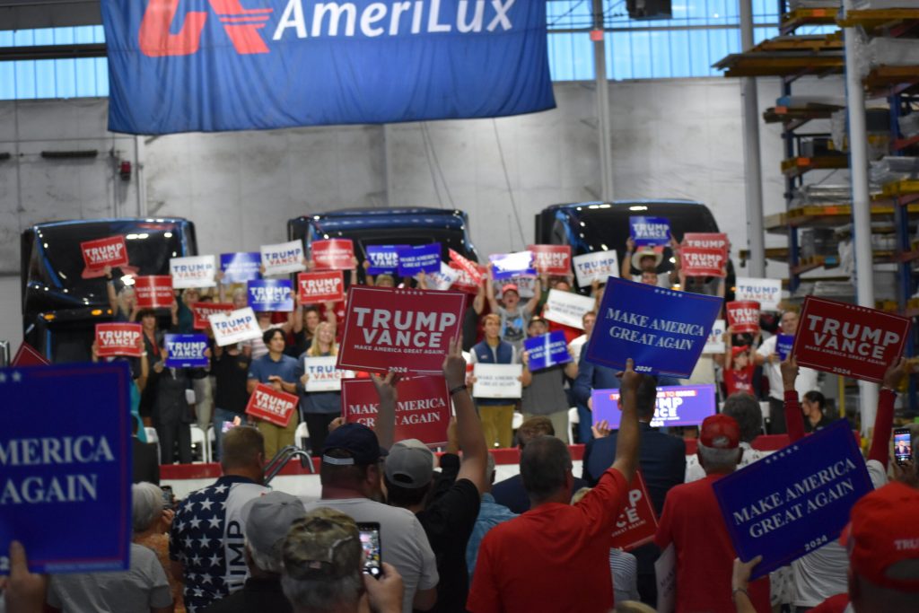 Supporters of Republican former President Donald Trump and Vice Presidential candidate JD Vance raise signs during a rally in De Pere Wednesday, Aug. 28, 2024. Joe Schulz/WPR