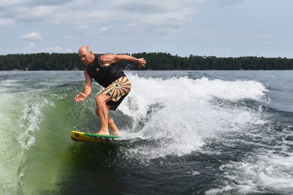 Mike Scandin wake surfs on Lake Minocqua on July 22, 2024. Danielle Kaeding/WPR