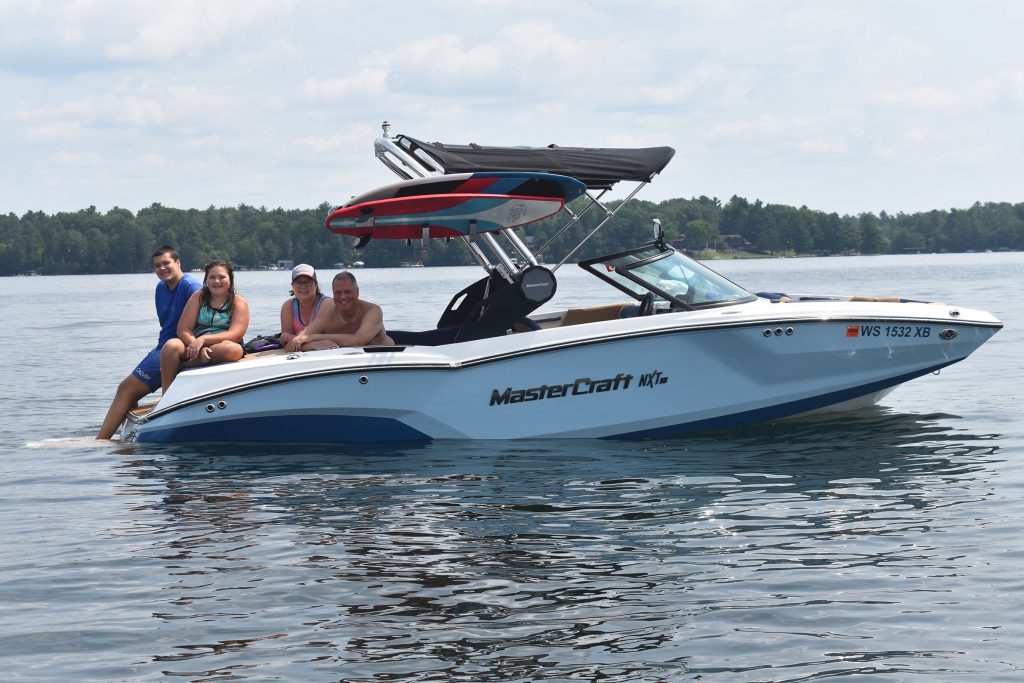 Rolf Eckert and his wife Jennifer with their two kids Charlotte and Max. The family enjoys wake surfing together while vacationing on Lake Minocqua. Danielle Kaeding/WPR