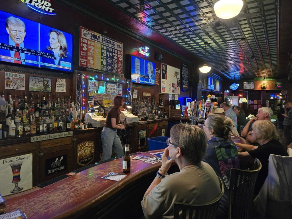 Democrats at Scooters Bar in Eau Claire watch the first presidential debate between former President Donald Trump and Democratic Vice President Kamala Harris. Rich Kremer/WPR