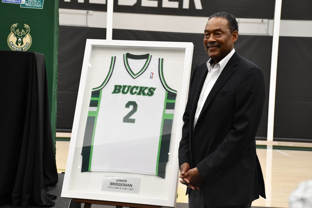 Junior Bridgeman poses with his retired jersey after being announced as a new Milwaukee Bucks owner. Photo by Jeramey Jannene.