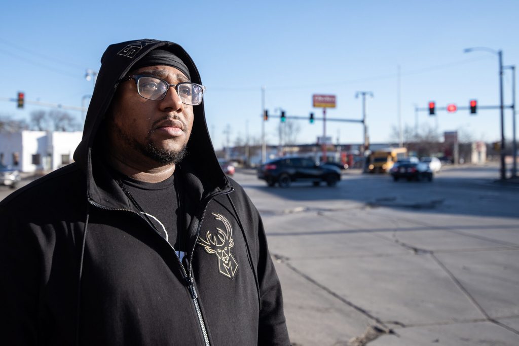 Activist Vaun Mayes stands at a busy intersection Thursday, Feb. 1, 2024, in Milwaukee, Wis. Angela Major/WPR