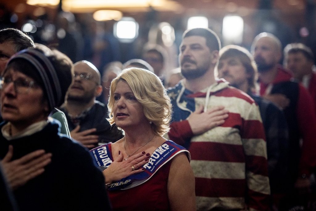 Trump rally attendees stand for the national anthem Tuesday, April 2, 2024, at Hyatt Regency in Green Bay, Wis. Angela Major/WPR