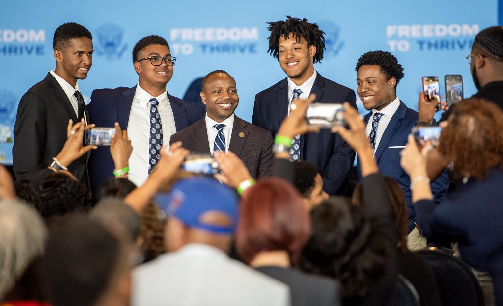 Milwaukee Mayor Cavalier Johnson, center, takes photos with people before Vice President Kamala Harris speaks Thursday, May 16, 2024, at Discovery World in Milwaukee, Wis. Angela Major/WPR