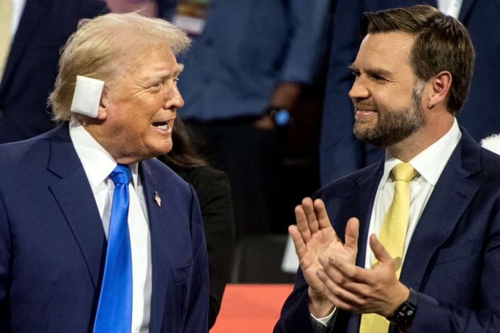 Former President Donald Trump and his vice presidential nominee JD Vance stand together in the stands during the second day of the RNC on Tuesday, July 16, 2024, at the Fiserv Forum in Milwaukee, Wis. Angela Major/WPR