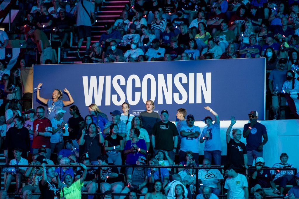 Attendees dance in front a sign at a campaign rally for Vice President Kamala Harris on Friday, Sept. 20, 2024, at the Alliant Energy Center in Madison, Wis. Angela Major/WPR