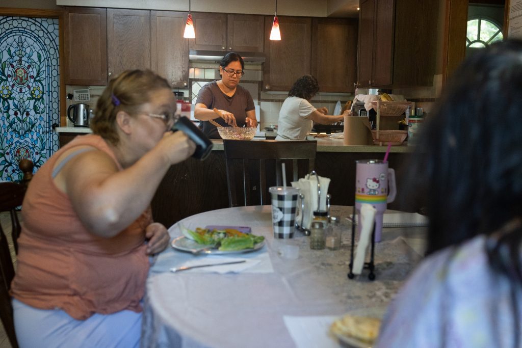 Rosa Landa, owner of Good Hand Care AFH, second from left, makes lunch for the facility’s residents on Aug. 23, 2024, in Madison, Wis. Landa considered closing the facility before a slight Medicaid reimbursement hike allowed the home to survive. (Joe Timmerman / Wisconsin Watch)