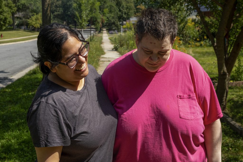 Rosa Landa, owner of Good Hand Care AFH assisted living facility, left, laughs with resident Bebette Gaus upon finishing a walk around the neighborhood on Aug. 23, 2024, in Madison, Wis. (Joe Timmerman / Wisconsin Watch)