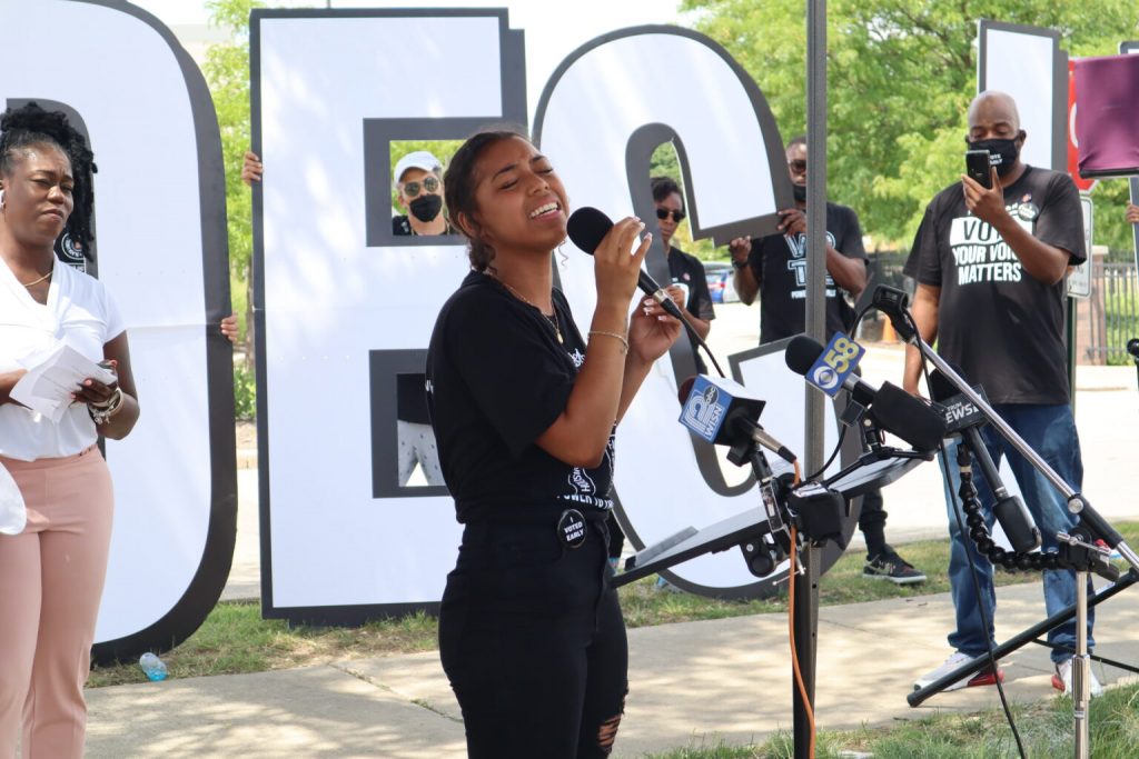 Mikayla Hughes singing during an early voting gathering at the Midtown Center in Milwaukee. (Photo | Isiah Holmes)