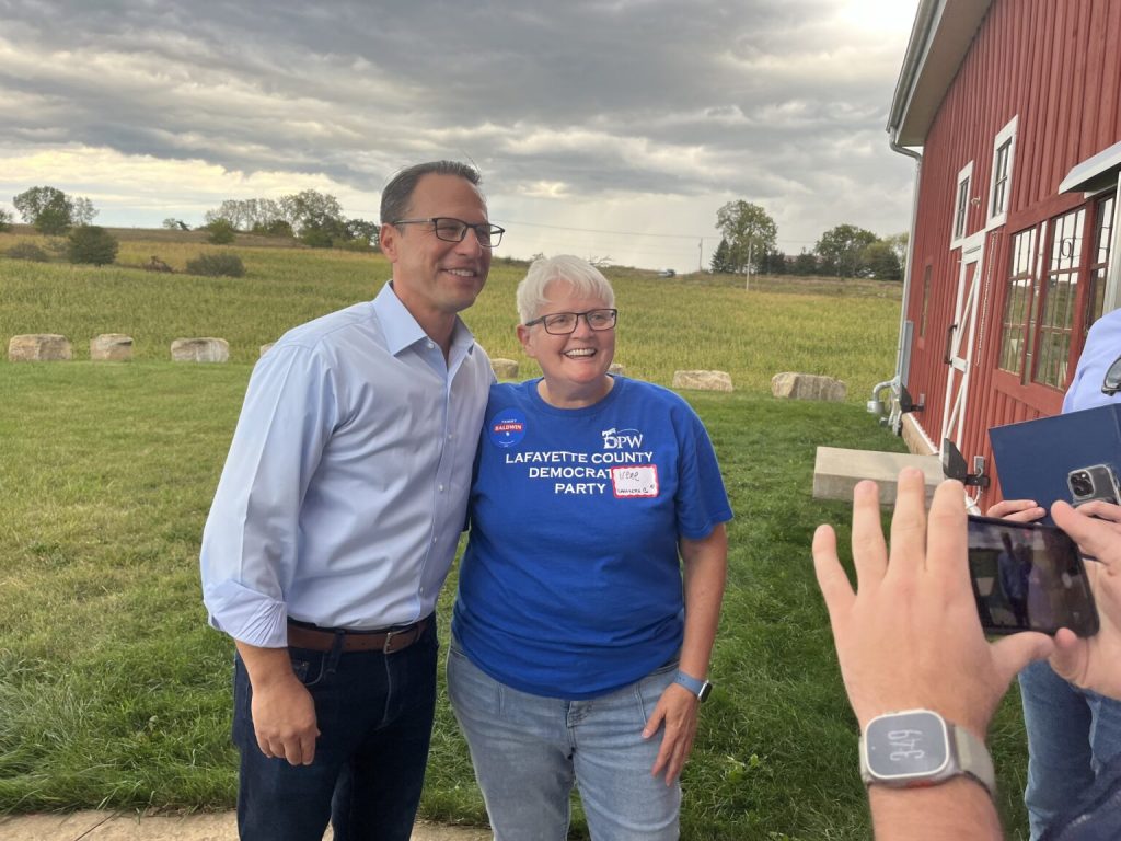 Pennsylvania Gov. Josh Shapiro and Lafayette County Democratic volunteer irene kendall. Shapiro campaigned in rural Wisconsin for Sen. Tammy Baldwin’s reelection Saturday. | Wisconsin Examiner photo