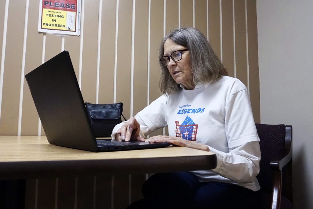 Linea Sundstrom, who co-leads Supermarket Legends, a Milwaukee voter advocacy group that registers voters outside grocery stores and other venues, discusses the group’s “voter rescue” effort. (Trisha Young / Wisconsin Watch)