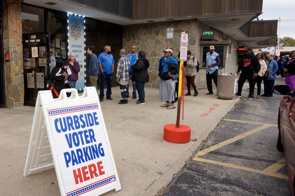 On the first day of early voting on Oct. 22, 2024, voters line up outside the former Milwaukee Western Bank at North 60th Street and West Capitol Drive. (Trisha Young / Wisconsin Watch)