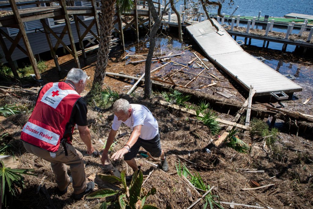 American Red Cross volunteer Kim Mailes offers support to a man in Steinhatchee, Florida, after Hurricane Helene devastated the area on Sept. 29, 2024. Photo Courtesy of the American Red Cross