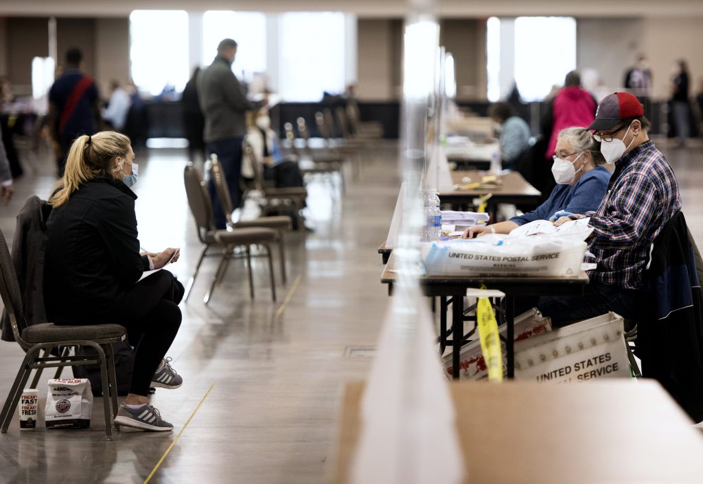 Observers, left, watch as workers recount ballots Monday, Nov. 23, 2020, at the Wisconsin Center in Milwaukee. Angela Major/WPR