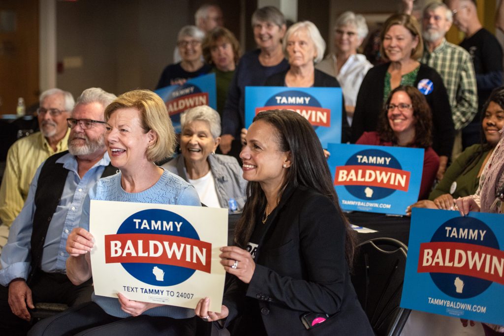 Sen. Tammy Baldwin and Alexis McGill Johnson, president and CEO of Planned Parenthood, pose for a group photo during a campaign stop Friday, Oct. 4, 2024, in Beaver Dam, Wis. Angela Major/WPR