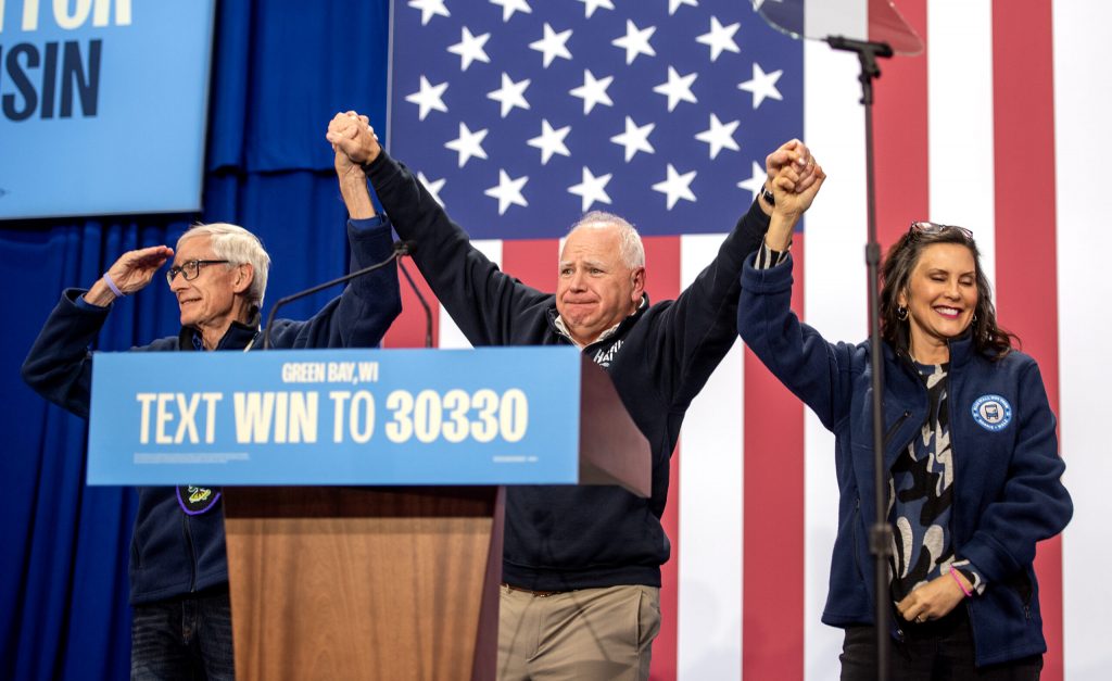 Gov. Tony Evers, left, Gov. Tim Walz, center, and Gov. Gretchen Whitmer, right, face the crowd after each speaking in favor of Vice President Kamala Harris’ presidential campaign Monday, Oct. 14, 2024, in Green Bay, Wis. Angela Major/WPR