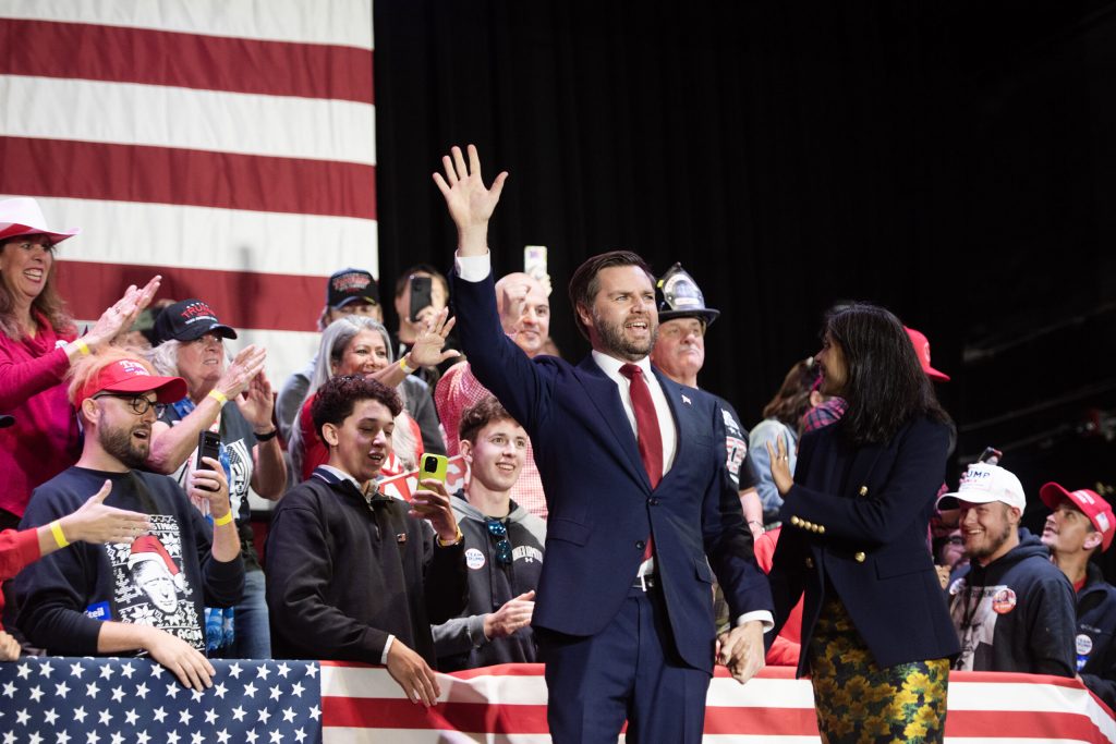 Republican vice presidential candidate JD Vance walks on stage with his wife, Usha Vance, on Monday, Oct. 28, 2024, at Racine Memorial Hall in Racine, Wis. Angela Major/WPR