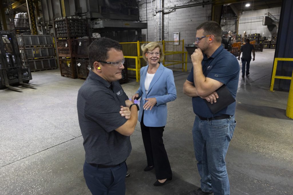 U.S. Sen. Tammy Baldwin, D-Wis., center, tours the Wisconsin Aluminum Foundry on Sept. 4, 2024, in Manitowoc, Wis. (Joe Timmerman / Wisconsin Watch)