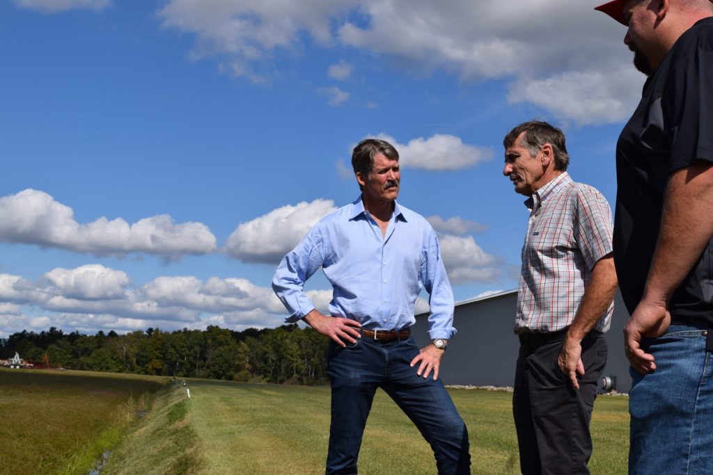 Republican U.S. Senate candidate Eric Hovde speaks with Bill Bosshard at his cranberry farm in Tomah, Wis. on Sept. 24, 2024. Hope Kirwan/WPR