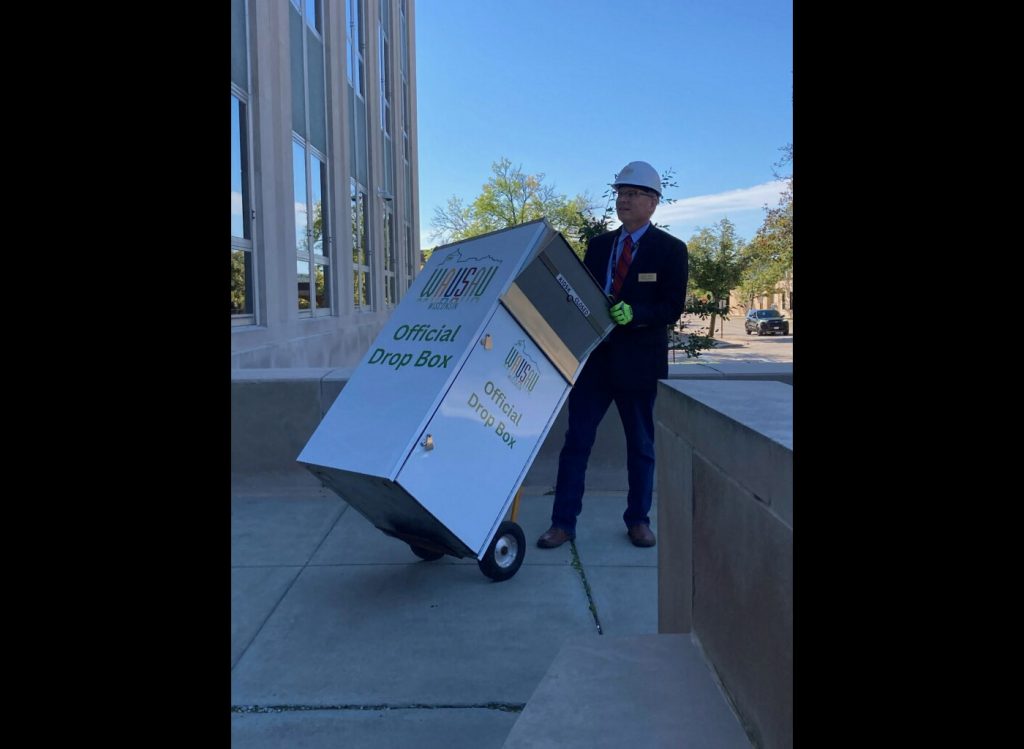 Wausau Mayor Doug Diny removes a ballot drop box from outside Wausau City Hall on Sept. 22, 2024. Photo obtained by WPR