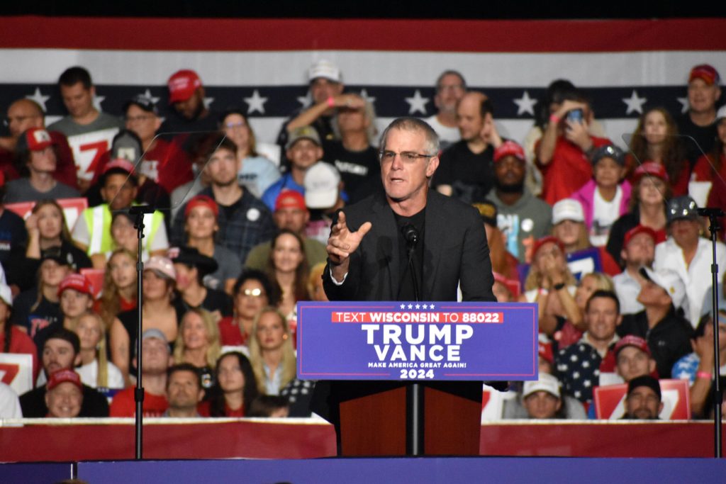 Former Packers quarterback Brett Favre speaks during a Trump rally in Ashwaubenon, Wis., on Oct. 30, 2024. Joe Schulz/WPR