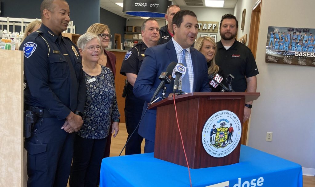 Attorney General Josh Kaul is joined by Wisconsin health officials and law enforcement at Forward Pharmacy Monona to encourage people to return old medications. Anna Marie Yanny / WPR.