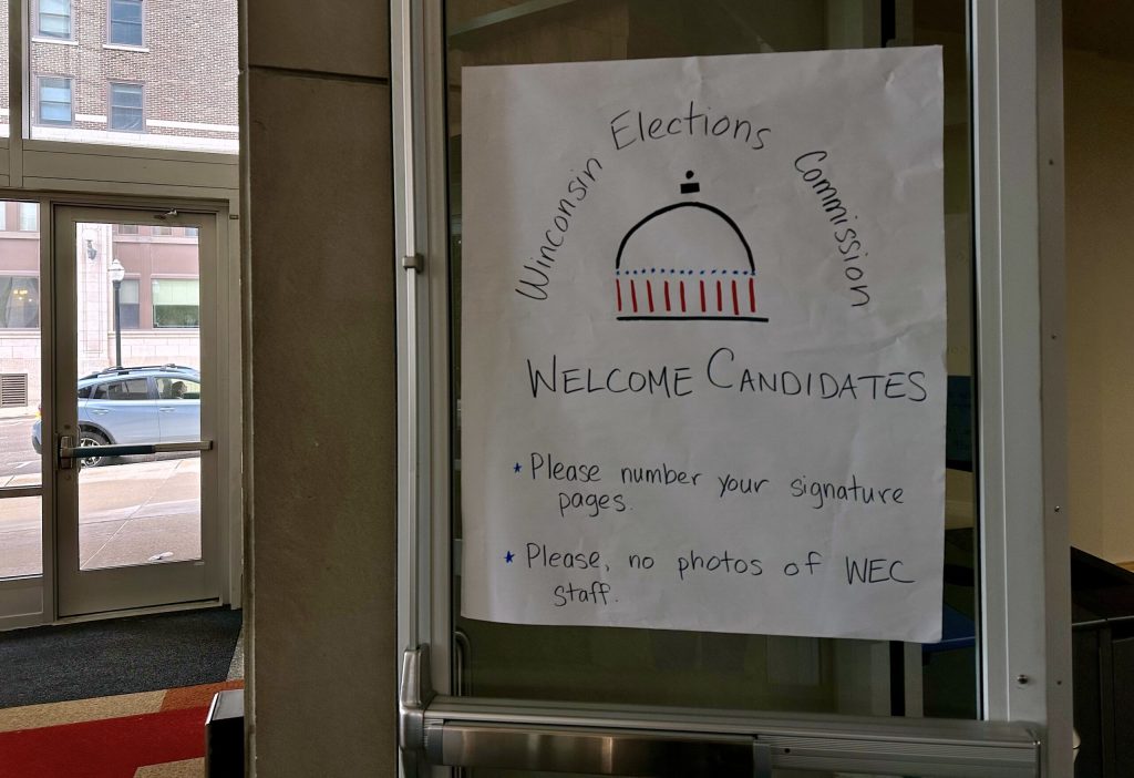 A sign at the door to the Wisconsin Elections Commission in Madison, Wis., on June 3, 2024. Anya van Wagtendonk/WPR