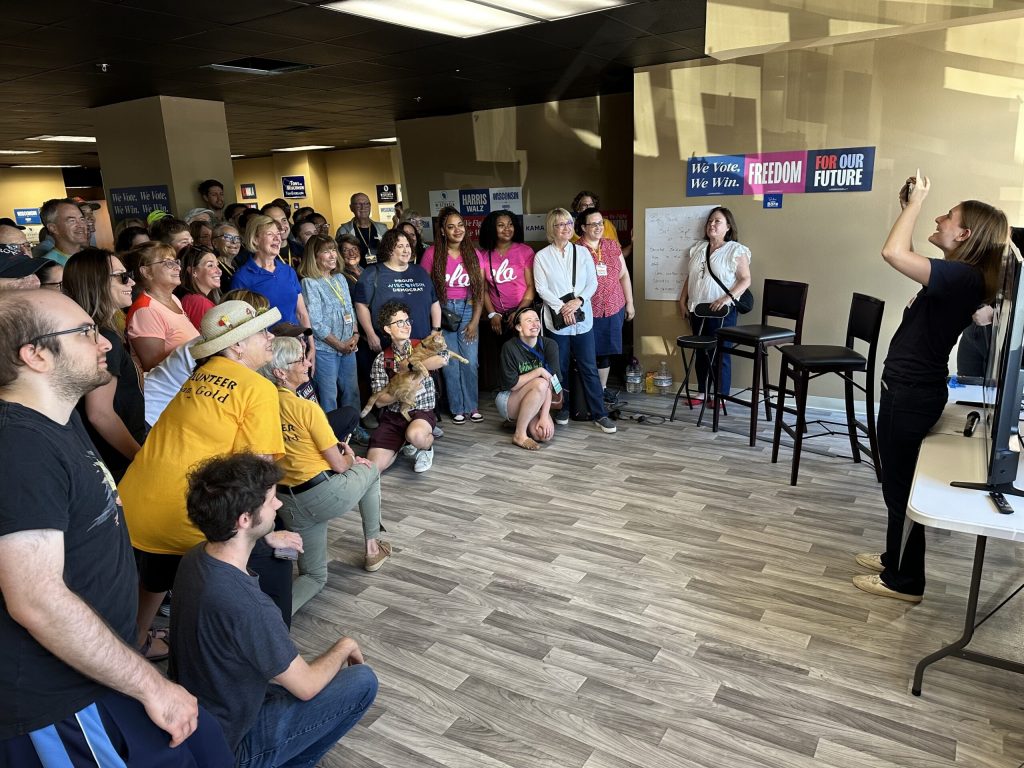 U.S. Sen. Tammy Baldwin poses with a group of volunteers before they knock on doors in support of Democratic candidates on Sept. 21, 2024, in Madison, Wis. Anya van Wagtendonk/WPR