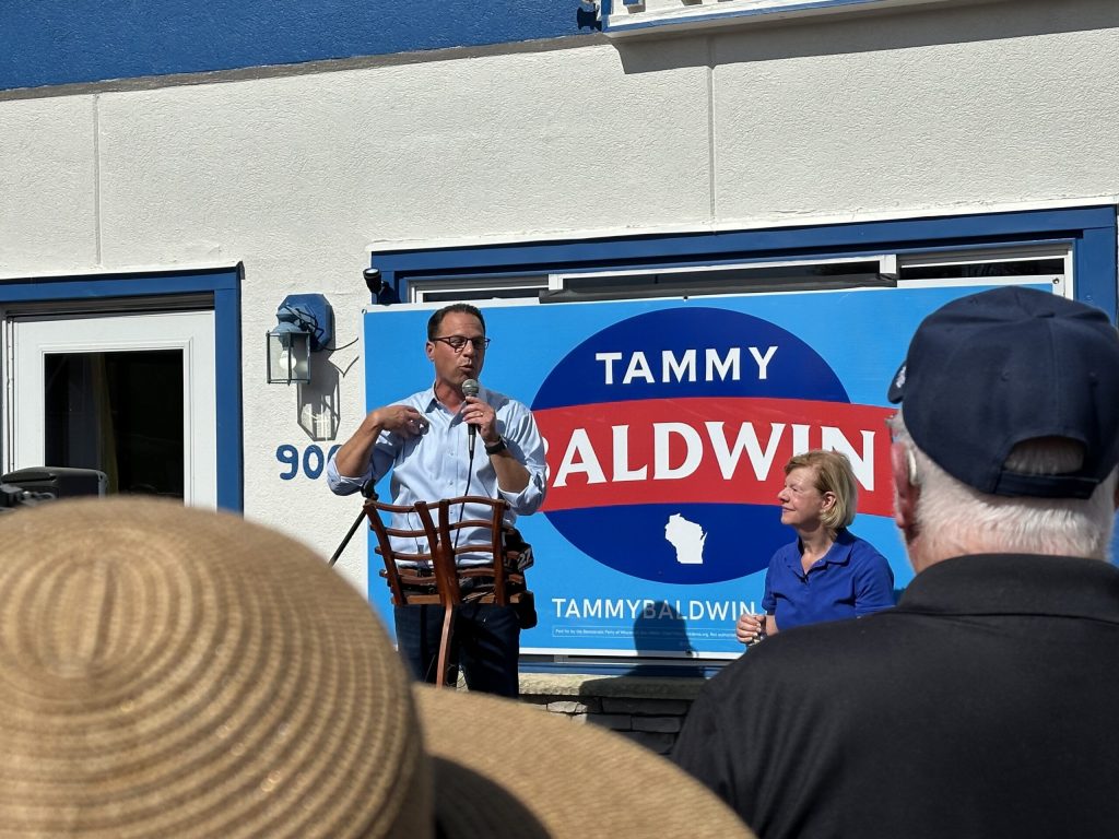 Pennsylvania Gov. Joshua Shapiro campaigns with Wisconsin U.S. Sen. Tammy Baldwin in Richland Center, Wis., on Sept. 21, 2024. Anya van Wagtendonk/WPR