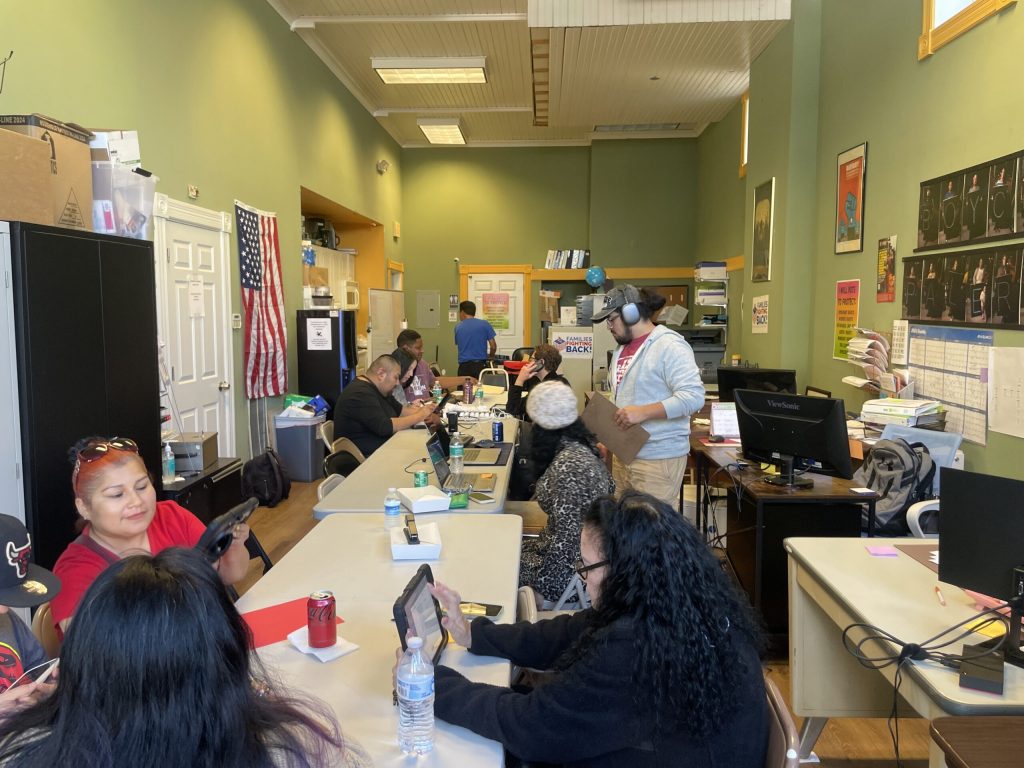 Volunteers and organizers assemble on Saturday, Oct. 5 in the Milwaukee office of Voces de La Frontera. They’re making phone calls and sending text messages on behalf of Democratic presidential candidate Kamala Harris. Sarah Lehr/WPR